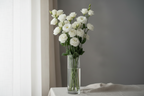long stem bouquet of white lisianthus in a tall elegant vase